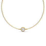 Round bezel natural diamond bracelet in yellow gold on a white background.